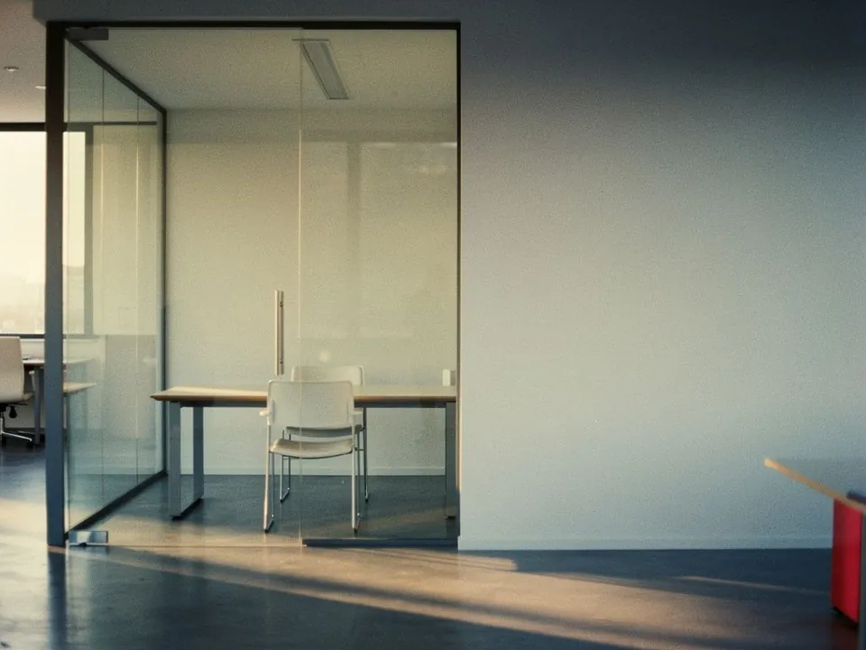 Empty modern office with a glass meeting room and a single chair